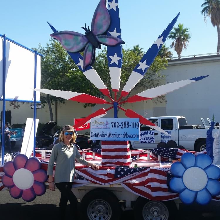 Our lovely founder Dee Powers in front of our Veterans Day Parade float! 